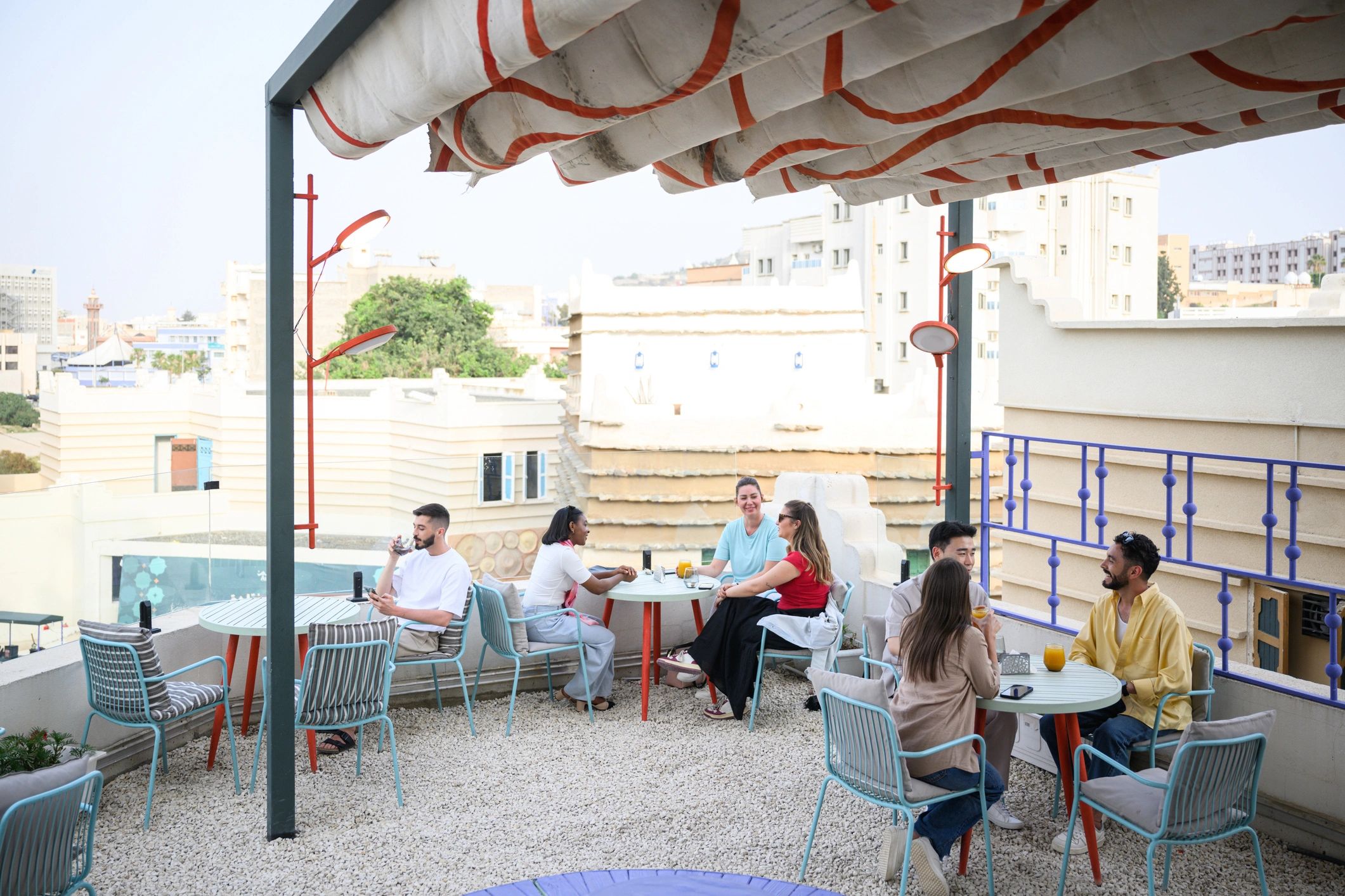 Friends gathering at an outdoor bar terrace